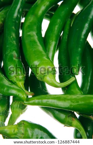 spices : A bunch of spicy green hot chili peppers isolated over white background