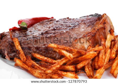 meat food : grill beef steak with potato chips and dry red hot chili peppers  on white round plate isolated on white background