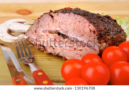 hot beef on transparent plate over wood table