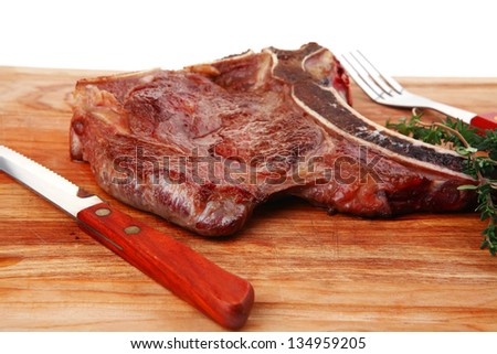 meat food : grilled beef spare rib on wooden plate with thyme isolated over white background