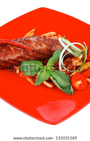 served roasted beef meat steak on potatoes over red dish isolated over white