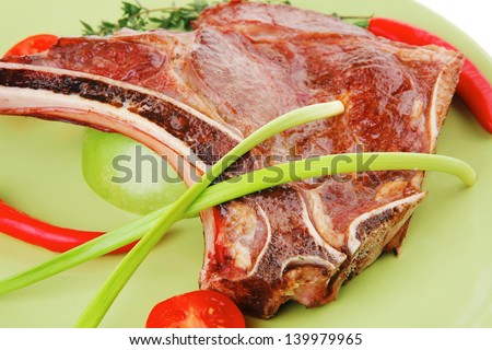 meat food : grilled beef spare rib on green dish with thyme pepper and tomato isolated over white background