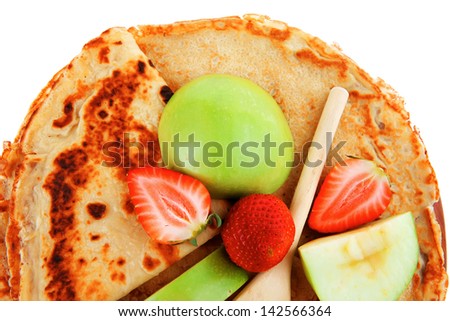baked and fruits : pancake with honey strawberries and apple isolated over white background on wooden plate