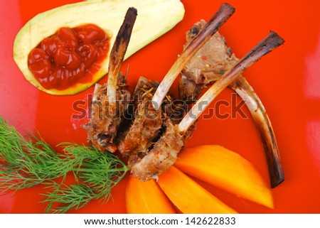 meat food : grilled lamb ribs served with mango fruit and filled avocado on red dish