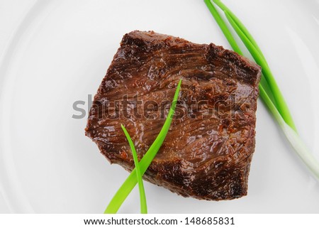 meat food : roasted fillet mignon on white plate with green sprouts isolated over white background