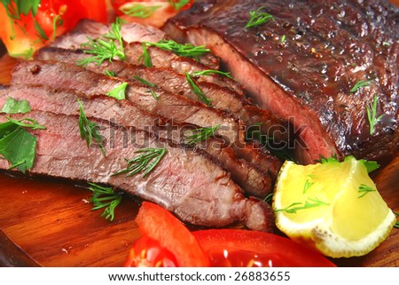 roast beef meat slices served on wood tray