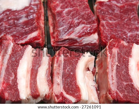 fresh red uncooked cuts of meat two row