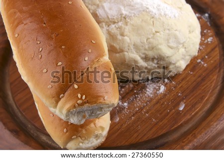 two french loaf and white dough on wood top view