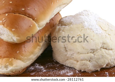 two french loaf and white dough on wood
