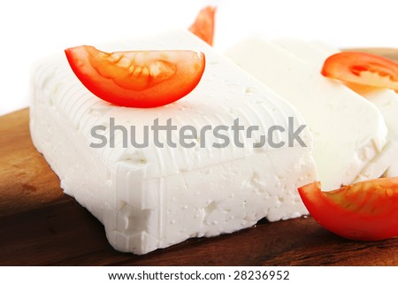 white soft goat cheese on cutboard over white