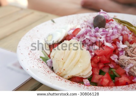 greece salad served on big white dish