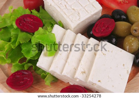 soft cheese served with vegetables on plate