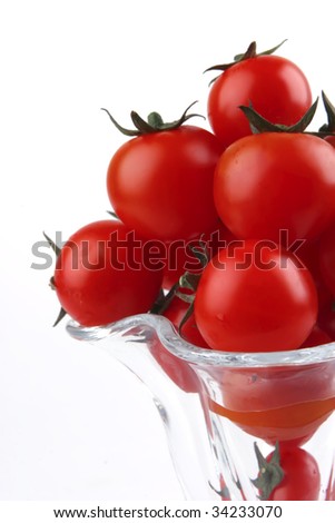 tomato cherry in crystal bowl over white background
