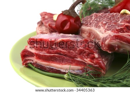 fresh beef rib\'s on dish with greenery