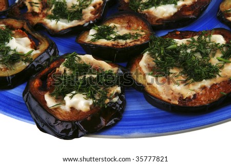 gold grilled eggplant served on dish over white