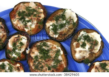 gold grilled eggplant served on dish over white
