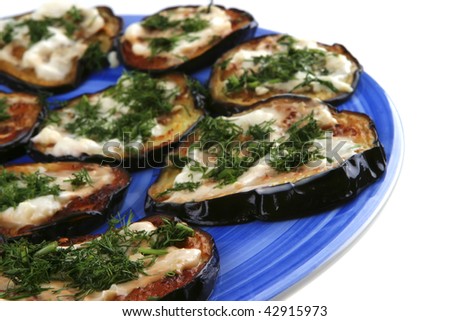 grilled egg plant on blue dish over white