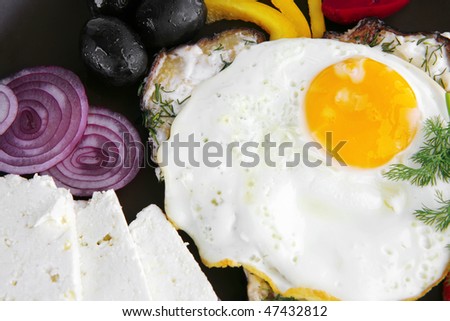 fresh fried egg served on red dish with vegetables