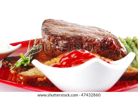 beef chunk on red dish with seasoning