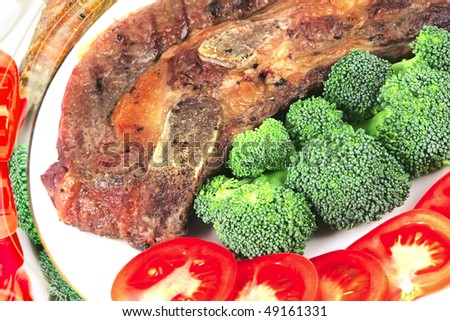 gold fat roast steak with bone on white dish