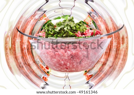 mince meet inside transparent bowl over white