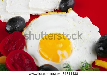 fried egg on red dish with vegetables