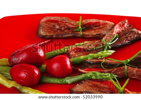 red meat slices and vegetables on red plate