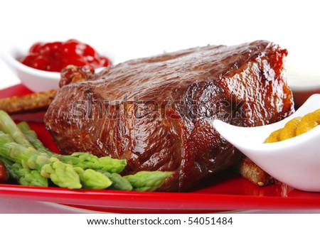bbq meat with spices on red dish