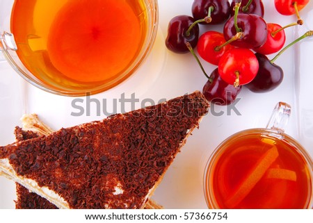 english cake and tea with cherry on white plate