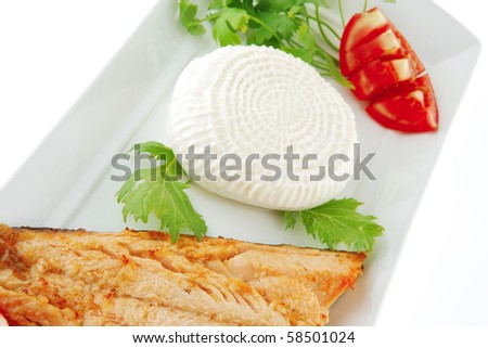 chinook steak and cheese on white plate with tomatoes