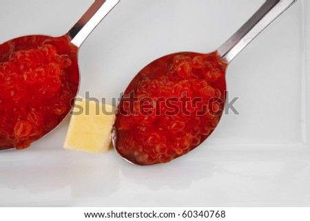 fresh red caviar on spoon over white plate