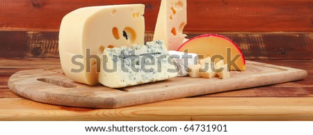 different type of cheese served on wood
