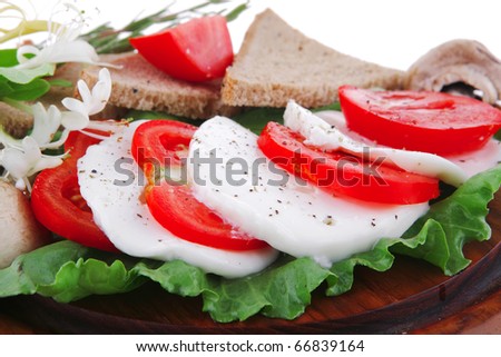 white cheese slices and vegetables on wood