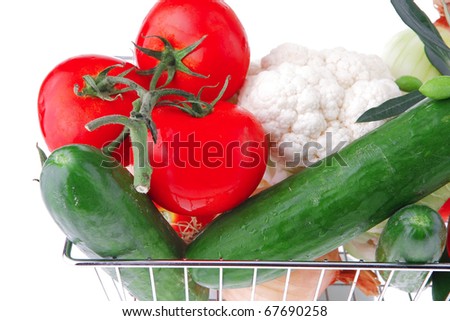 ripe vegetables in metal store basket on white