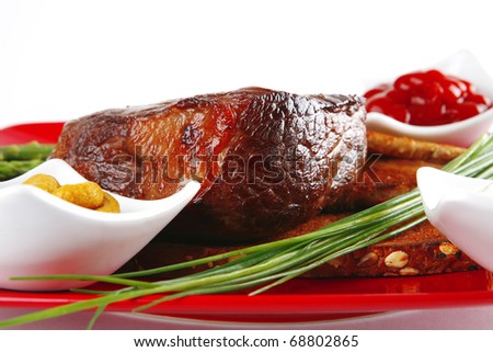 grilled beef with toasted bread on red dish