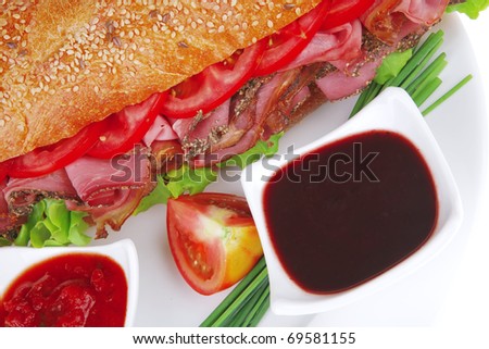 french sandwich : fresh white baguette with smoked sausage isolated over white