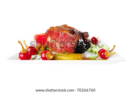 fat hot roast beef meat chunk with red and green peppers on white plate isolated over white background