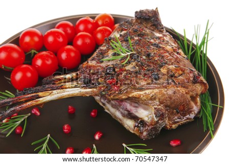 roasted rack of ribs served on plate isolated over white background . shallow dof