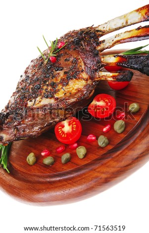 ribs on wooden plate over white background