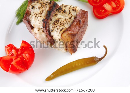 roast beef steak with melted cheese over white