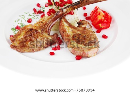 main course: grilled ribs with rice and tomatoes on white plate over white background