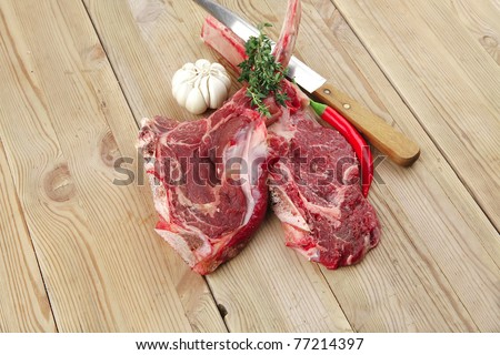 fresh spare ribs : raw lamb with thyme , garlic and red chili pepper on wooden board