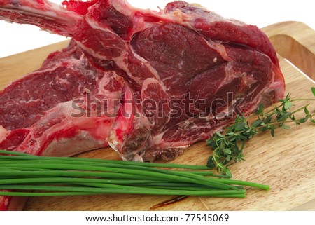fresh meat : raw beef spare ribs with thyme and green chives on wooden board isolated over white background