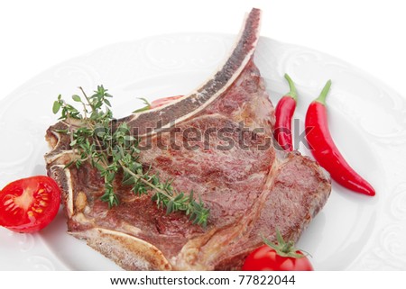 savory : grilled spare rib on white dish with thyme pepper and tomato isolated over white background