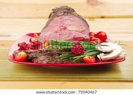 grilled barbecue on red dish with vegetables