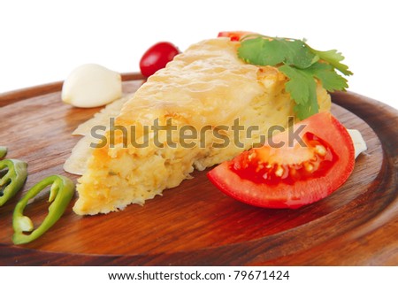 dairy food : cheese casserole piece on wooden plate tomatoes , chives , and garlic isolated over white background