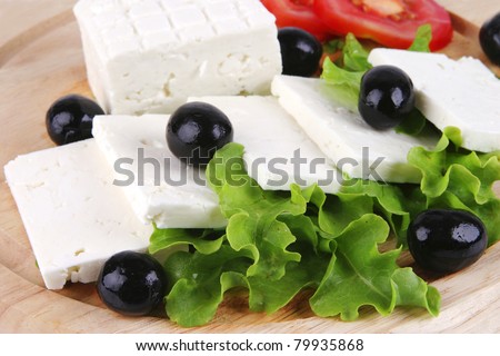 goat cheese with vegetables on wooden dish