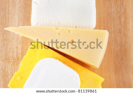 goat cheeses and yellow on wooden board