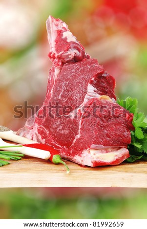 uncooked meat : raw fresh beef rib ready to cooking with garlic and red hot pepper over wood isolated over white background