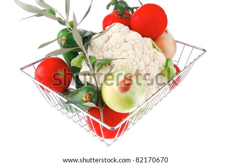 vegetables in metal store basket on white background